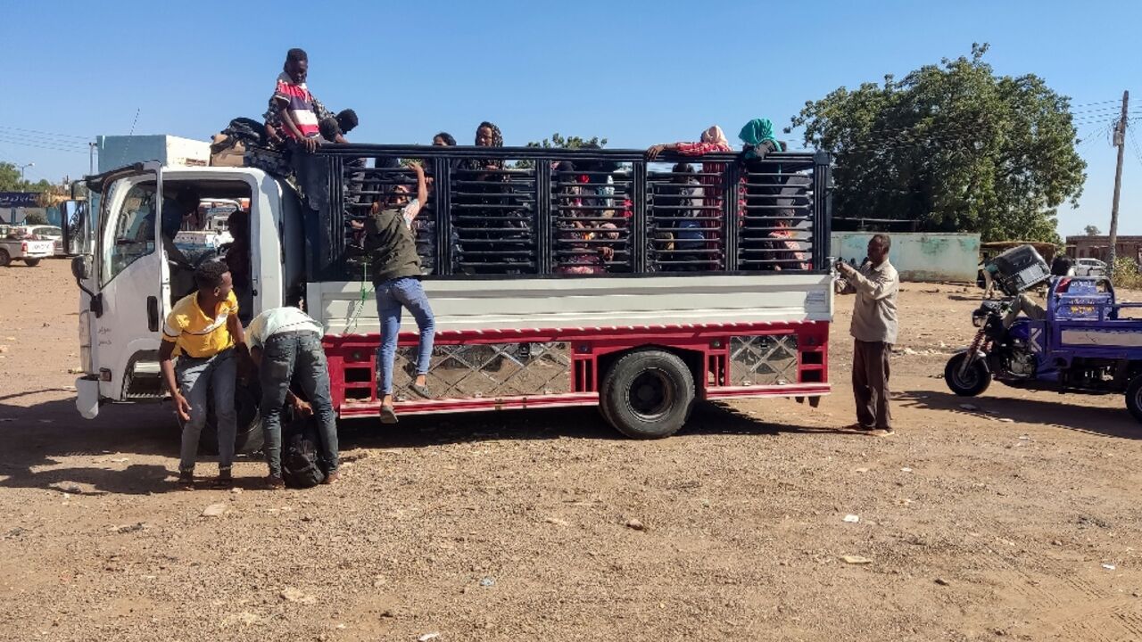 Displaced people fleeing from Wad Madani in Sudan's Al-Jazirah state arrive in Gedaref in the country's east