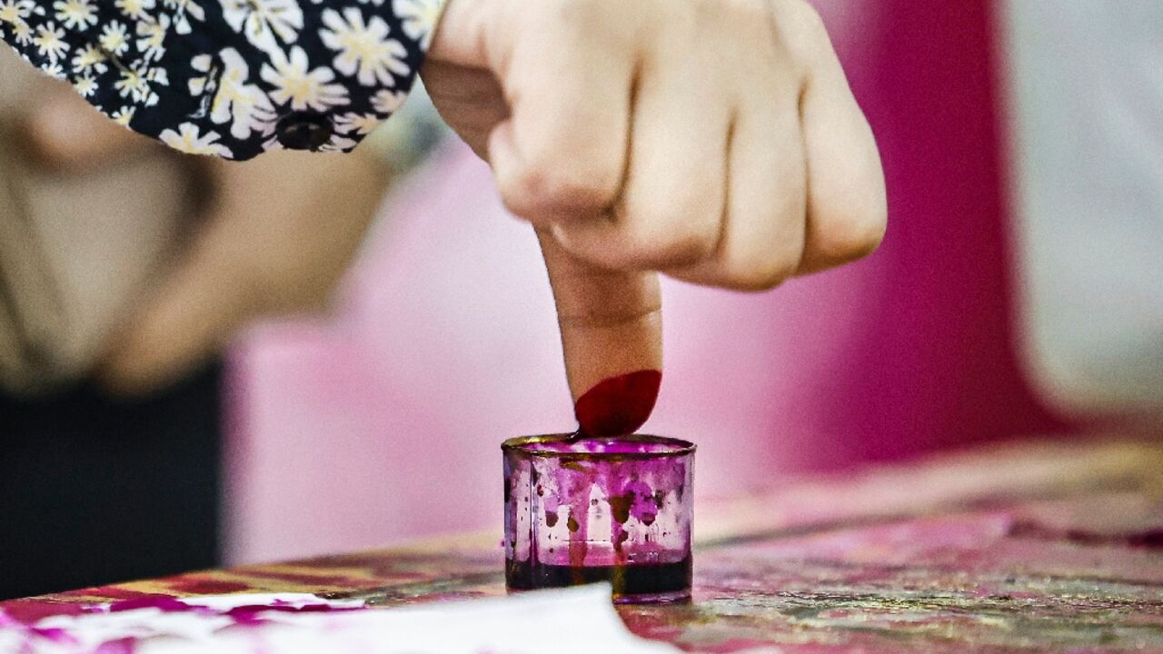 Proof of voting: an Egyptian woman stains her thumb with ink after voting in Cairo