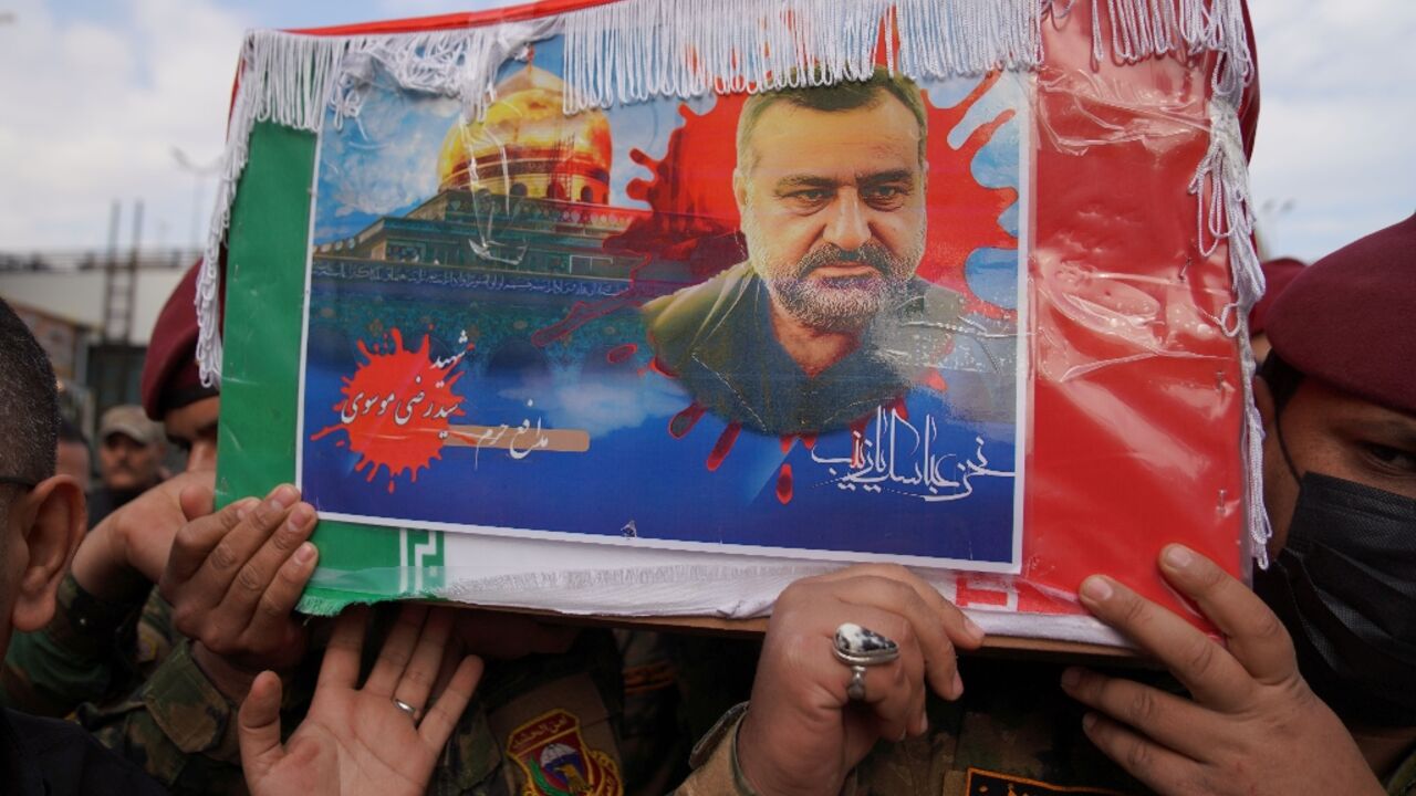 Honour guards carry the coffin of Razi Moussavi, a senior commander in the Quds Force of Iran's Islamic Revolutionary Guard Corps, in Iraq's holy city of Najaf