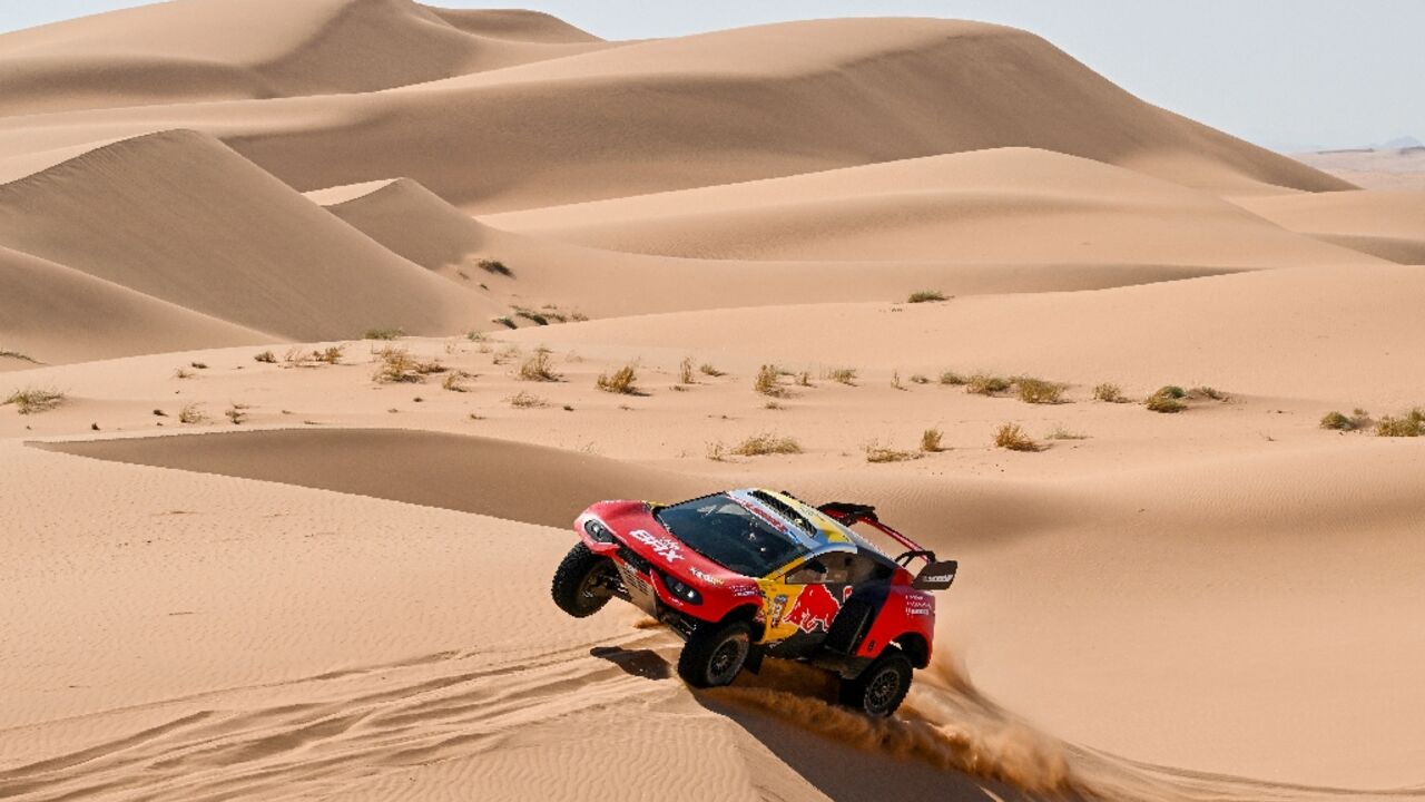 Heading for the rocks: Sebastien Loeb races through the dunes on stage 3 before suffering a series of punctures Heading for the rocks: Sebastien Loeb races through the dunes on stage 3 before suffering a series of punctures