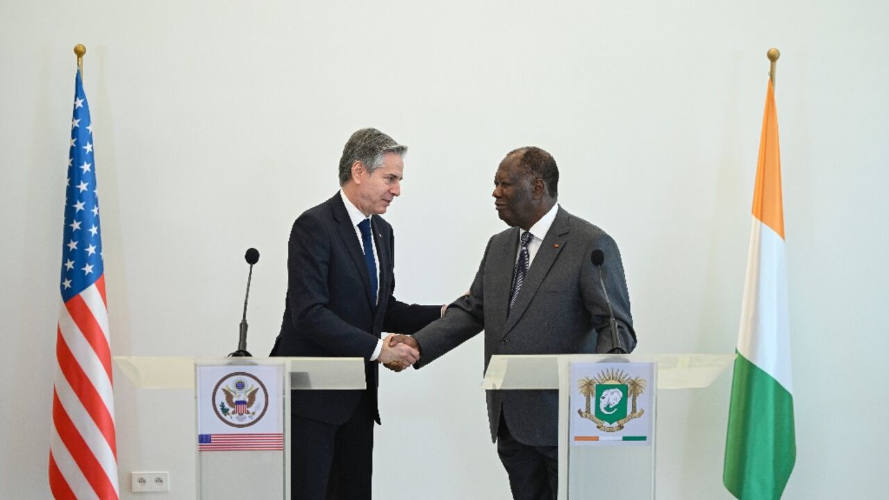 US Secretary of State Antony Blinken (L) met Ivorian President Alassane Ouattara (R) on the latest leg of a tour of African nations