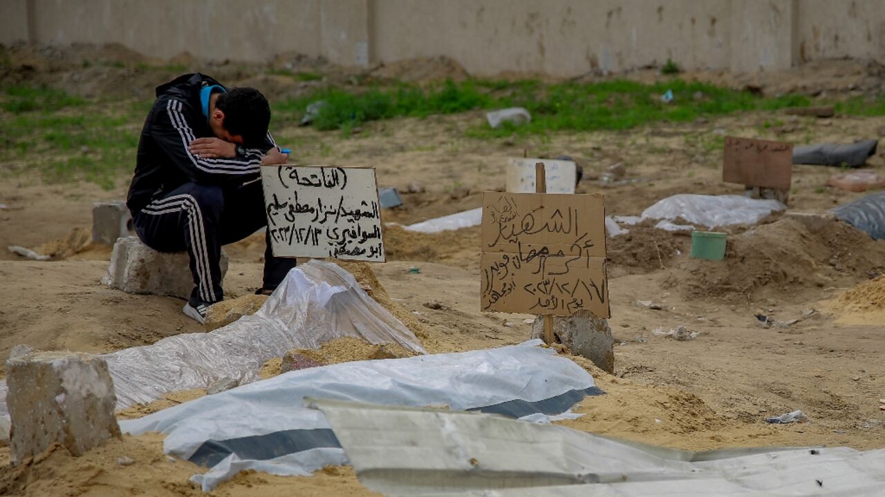 Graves and bodies at a makeshift cemetery near Gaza City's al-Shabiyah district Graves and bodies at a makeshift cemetery near Gaza City's al-Shabiyah district