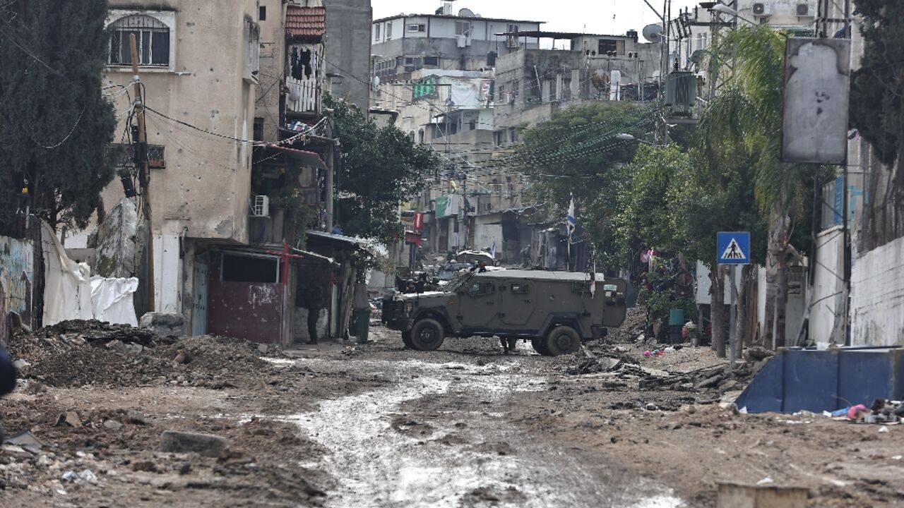 Israeli troops block off roads during a raid on Tulkarem refugee camp in the occupied West Bank