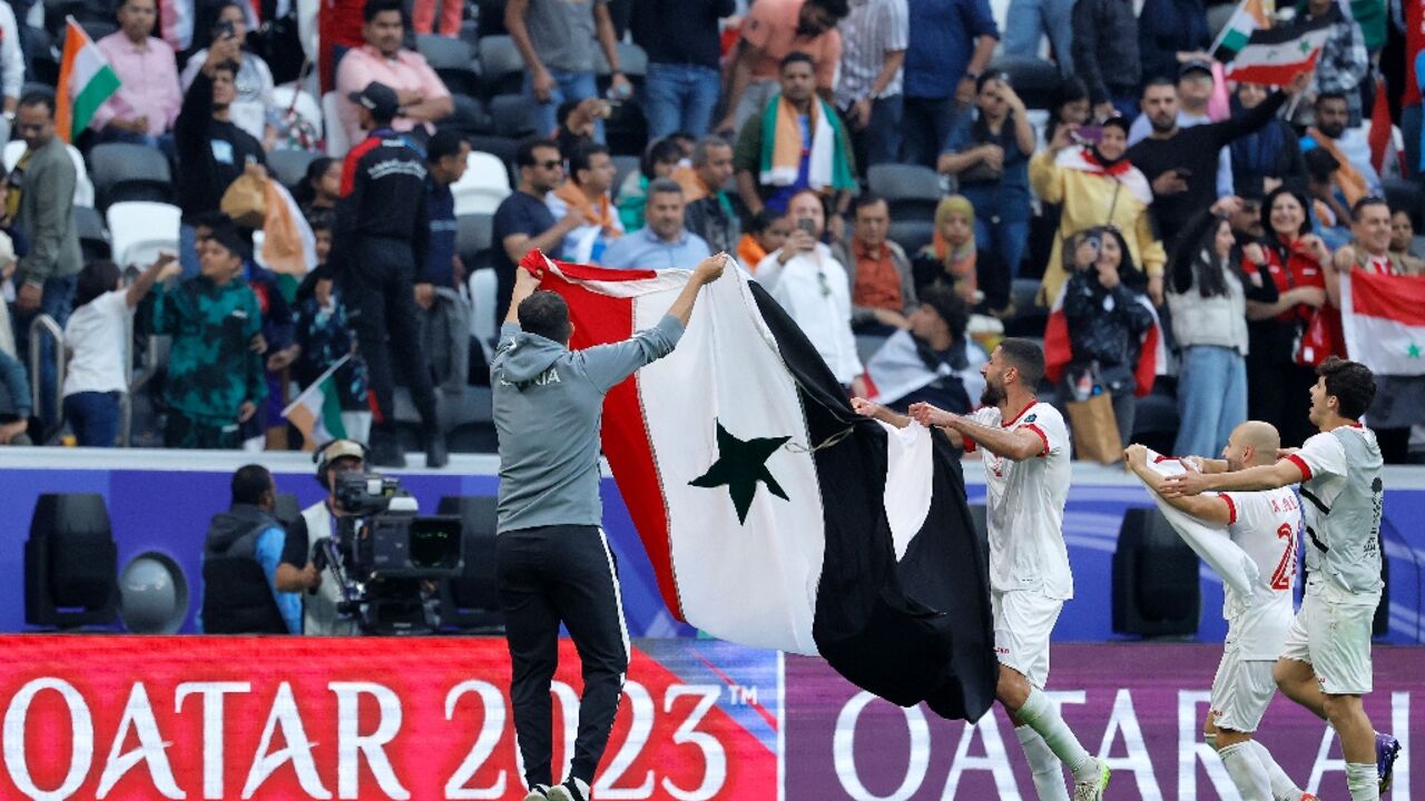Syria's players celebrate reaching the last 16 Syria's players celebrate reaching the last 16