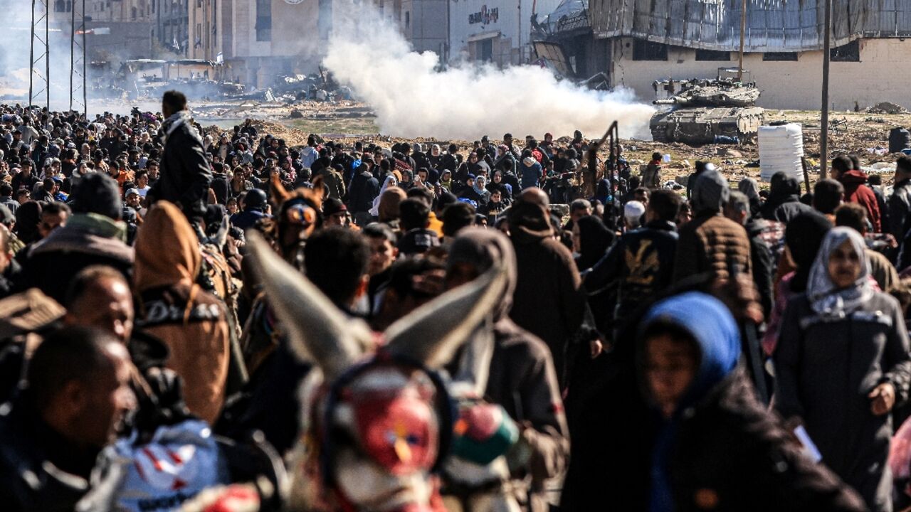 An Israeli tank moves as Palestinians flee Khan Yunis in the southern Gaza Strip 