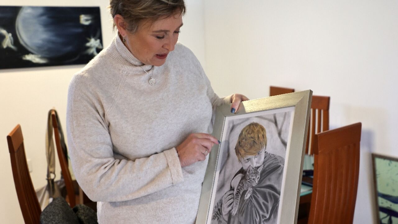 Iris Haim shows a portrait of her son Yotam Haim