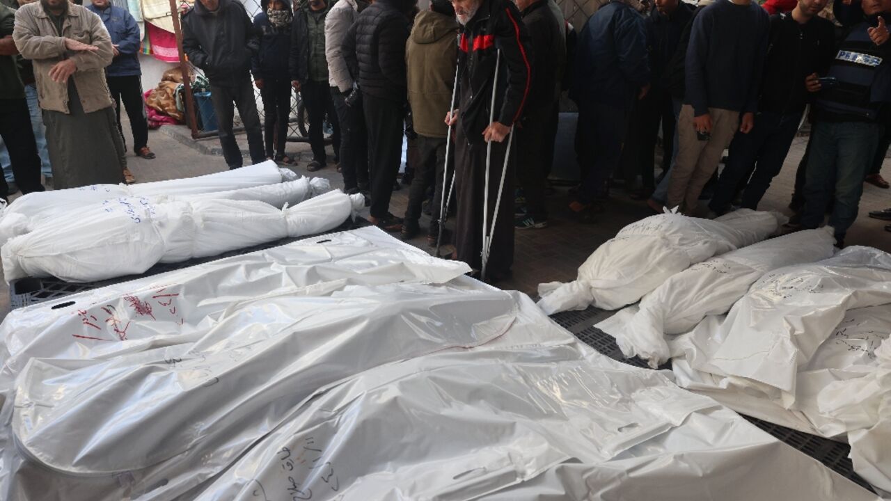 Palestinians in Rafah, the southern Gaza strip, mourn over bodies killed in Israeli bombardment 