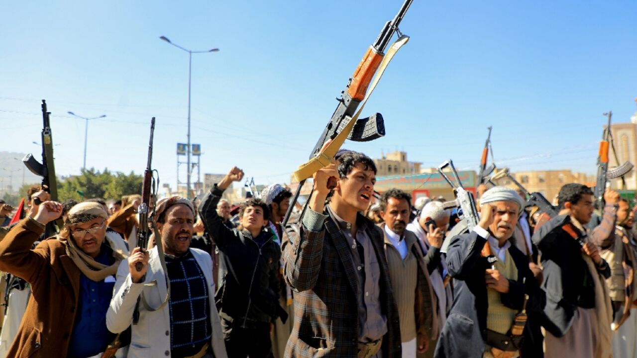 Huthi fighters brandish their weapons during a march in solidarity with the Palestinian people in Yemen's Huthi-controlled capital Sanaa on January 11, 2024