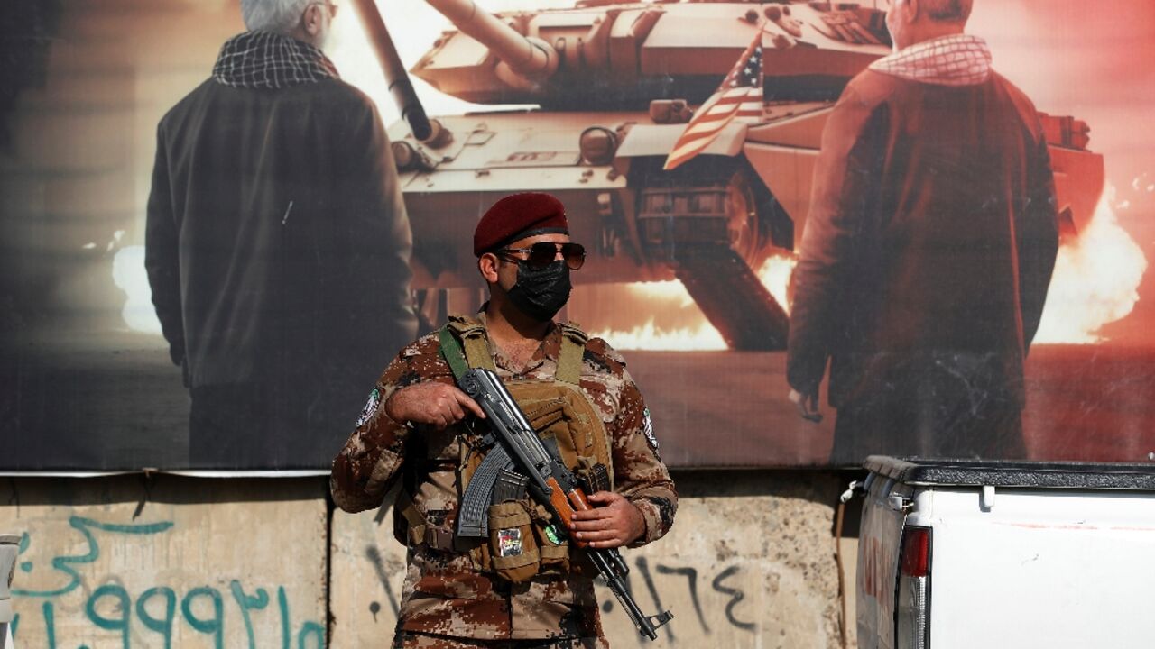 A paramilitary of the Hashed al-Shaabi (Popular Mobilisation) stands guard during the funeral in Baghdad of a fellow fighter killed in American air strikes targeting Iran-backed groups A paramilitary of the Hashed al-Shaabi (Popular Mobilisation) stands guard during the funeral in Baghdad of a fellow fighter killed in American air strikes targeting Iran-backed groups