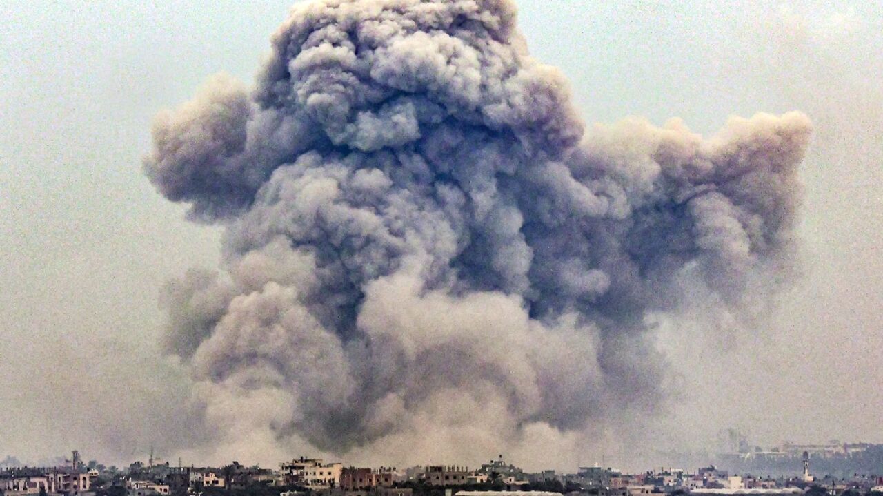 Seen from Rafah, smoke billows over Khan Yunis in the southern Gaza strip during Israeli bombardment 