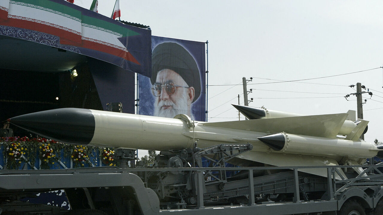 An Iranian navy missile is displayed during the army day military parade, outside the mausoleum of the late founder of Islamic republic, Ayatollah Khomeini (poster) in Tehran, April 18, 2007.