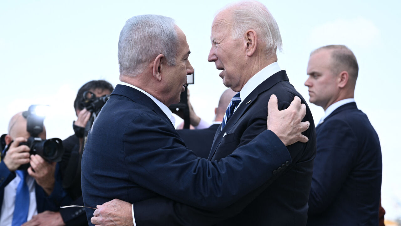 Israel Prime Minister Benjamin Netanyahu (L) greets US President Joe Biden upon his arrival at Tel Aviv's Ben Gurion airport on Oct. 18, 2023, amid the ongoing battles between Israel and the Palestinian group Hamas.