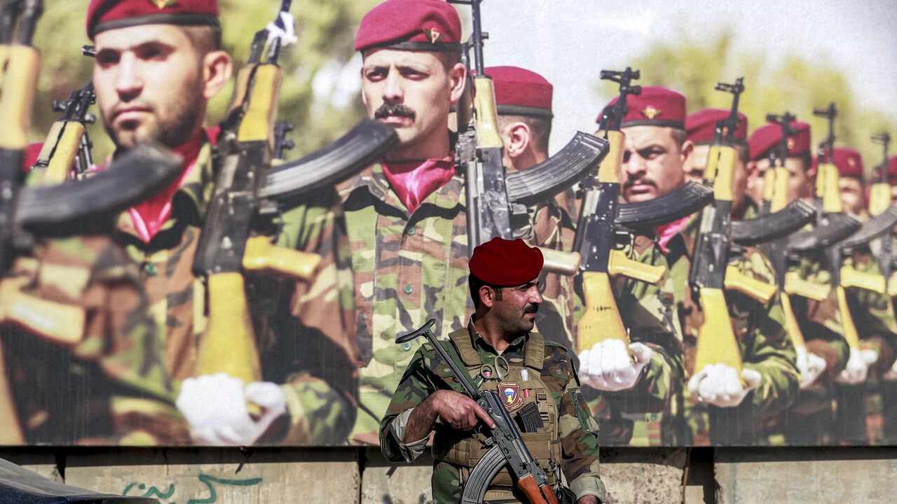 A member of Iraq's Special Operations Forces stands guard during the funeral of Hassan Hammadi al-Amiri, a fallen member of the group Kataib Hezbollah.