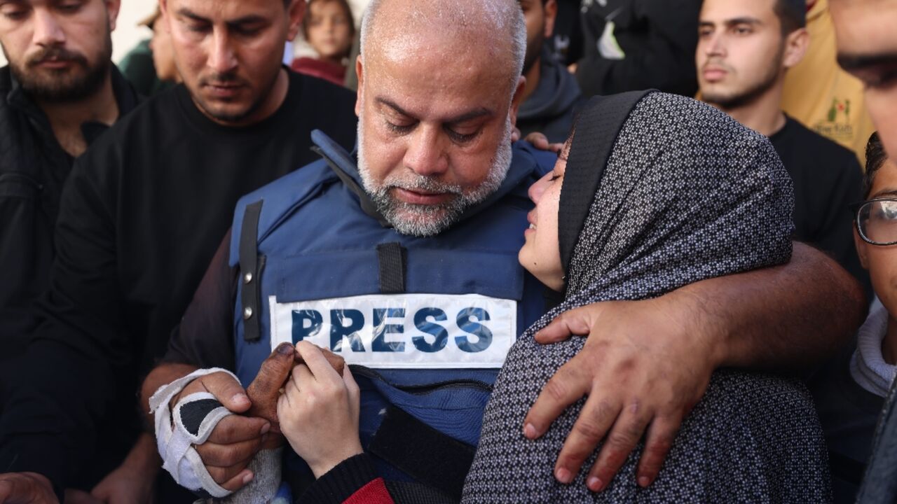 Al Jazeera's bureau chief in Gaza, Wael al-Dahdouh hugs his daughter during the funeral of his son Hamza Wael Dahdouh, a journalist, who was one of two reporters killed in an air strike in Rafah blamed on Israel Al Jazeera's bureau chief in Gaza, Wael al-Dahdouh hugs his daughter during the funeral of his son Hamza Wael Dahdouh, a journalist, who was one of two reporters killed in an air strike in Rafah blamed on Israel
