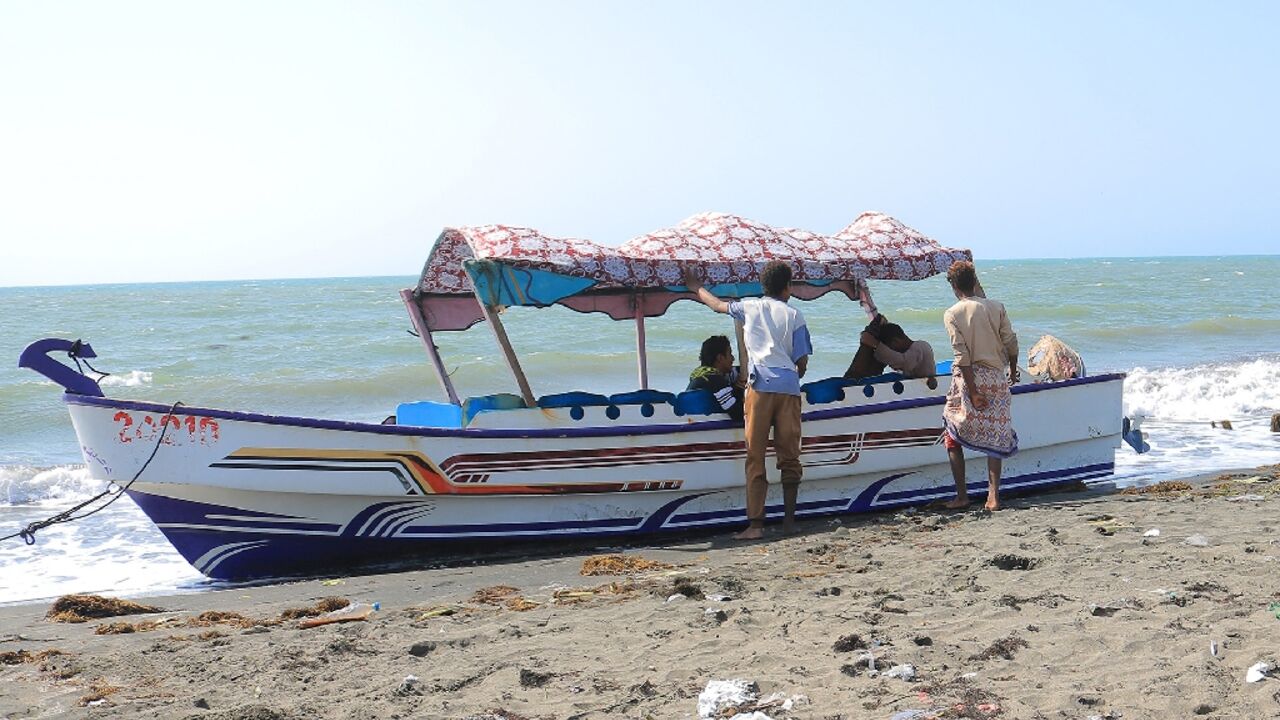 Yemenis ride a fishing boat on the coast of the Red Sea port of Hodeida