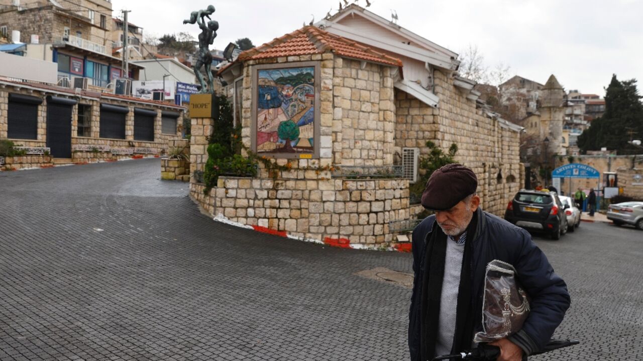 A man walks in an empty alley in Israel's northern city of Safed, amid ongoing cross-border tensions with Lebanon 