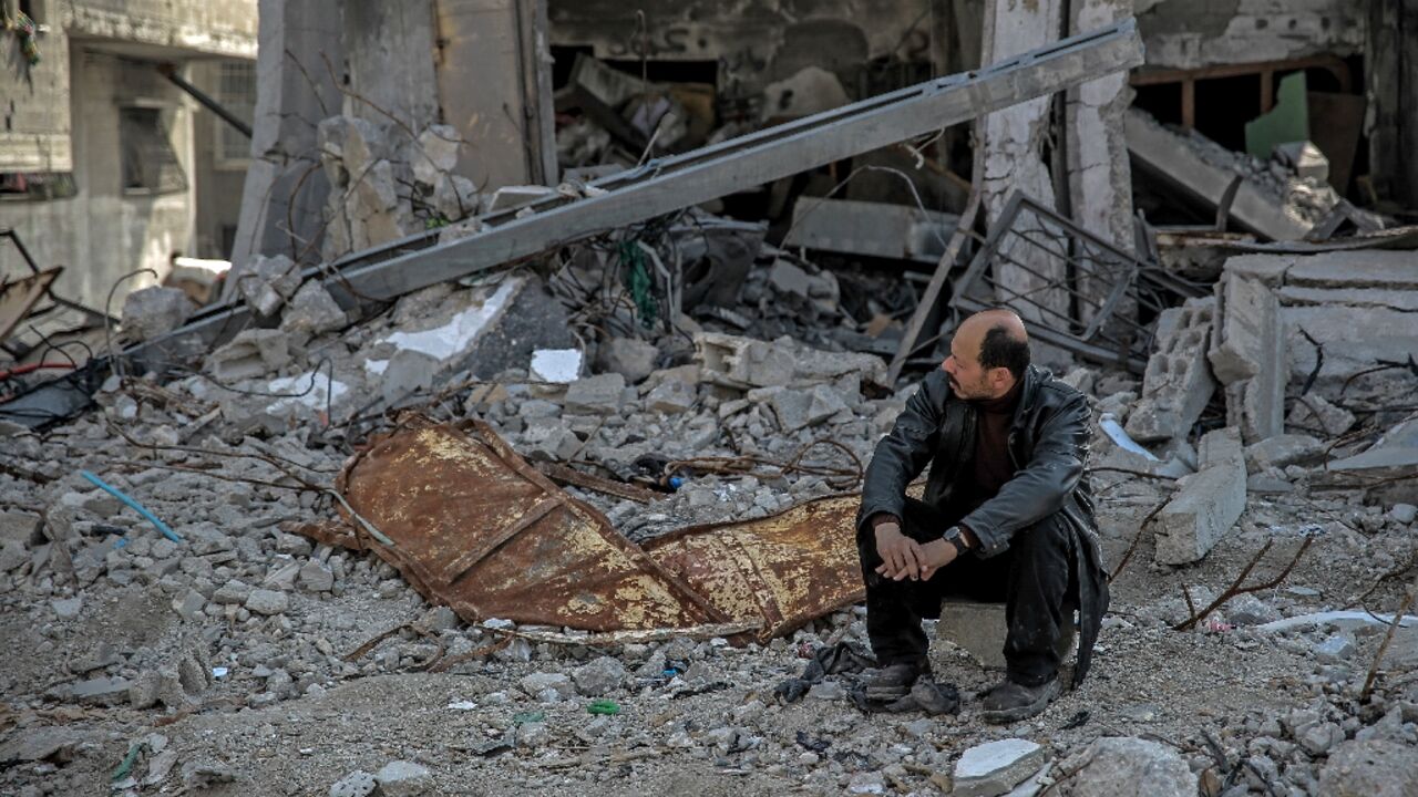 A Palestinian man sits amid the rubble of a building destroyed during Israeli strikes in Gaza City A Palestinian man sits amid the rubble of a building destroyed during Israeli strikes in Gaza City