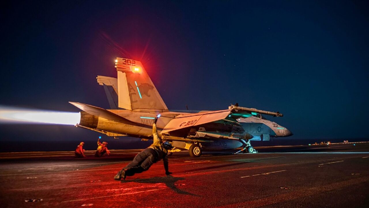 This image released by US Central Command on February 24, 2024 shows a fighter plane launching from the deck of the USS Eisenhower aircraft carrier in the Red Sea during operations against Huthi targets