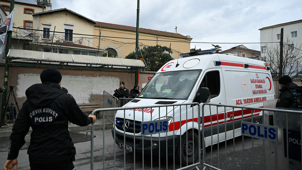 An ambulance leaves from Santa Maria Church as anti-riot police officers block the street after an attack in Istanbul, Turkey, Jan. 28, 2024.