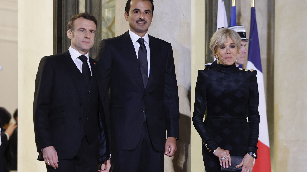 French President Emmanuel Macron (L) and his wife Brigitte Macron (R) greet Qatar's Emir Sheikh Tamim bin Hamad al-Thani (C) during an official visit to the Elysee Palace, in Paris on February 27, 2024. Macron and the Emir of Qatar take stock of current efforts to secure a ceasefire and the release of hostages in Gaza, as well as ways of speeding up the implementation of a Palestinian state in order to bring a lasting end to the conflict. (Photo by Ludovic MARIN / AFP) (Photo by LUDOVIC MARIN/AFP via Getty