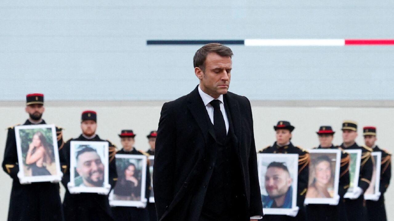 Members of the presidential guard held up images of the victims Members of the presidential guard held up images of the victims