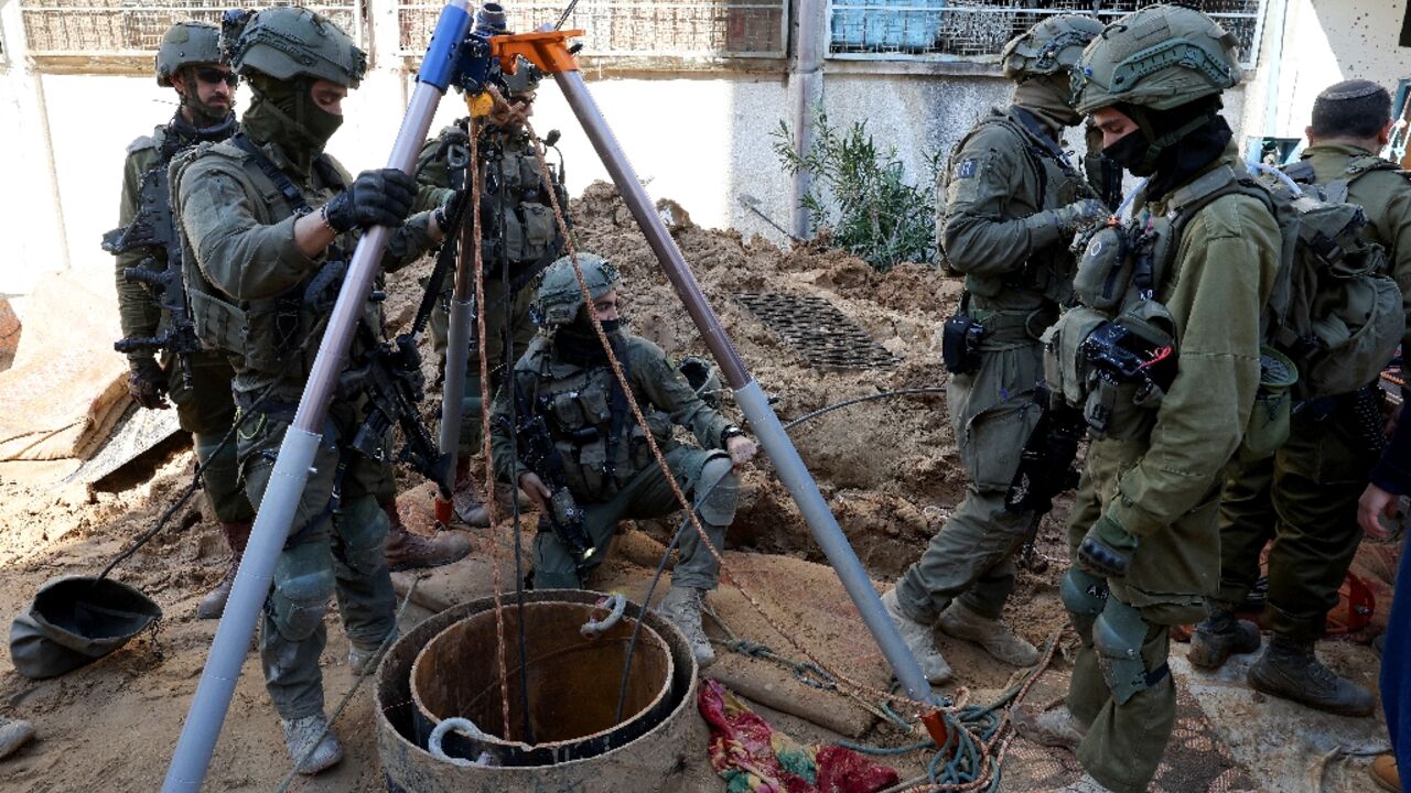 This picture taken during a media tour organised by the Israeli army on February 8 shows Israeli soldiers checking a shaft inside the evacuated Gaza City headquarters compound of the United Nations agency for Palestinian refugees (UNRWA)