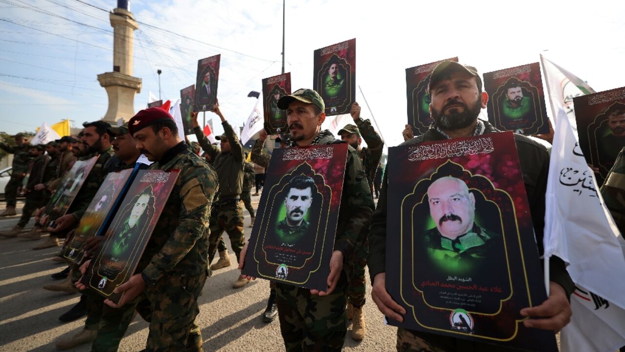 Members of Iraq's Hashed al-Shaabi (Popular Mobilization) paramilitary forces carry portraits on February 4, 2024 showing people killed the previous day in US strikes in western Iraq