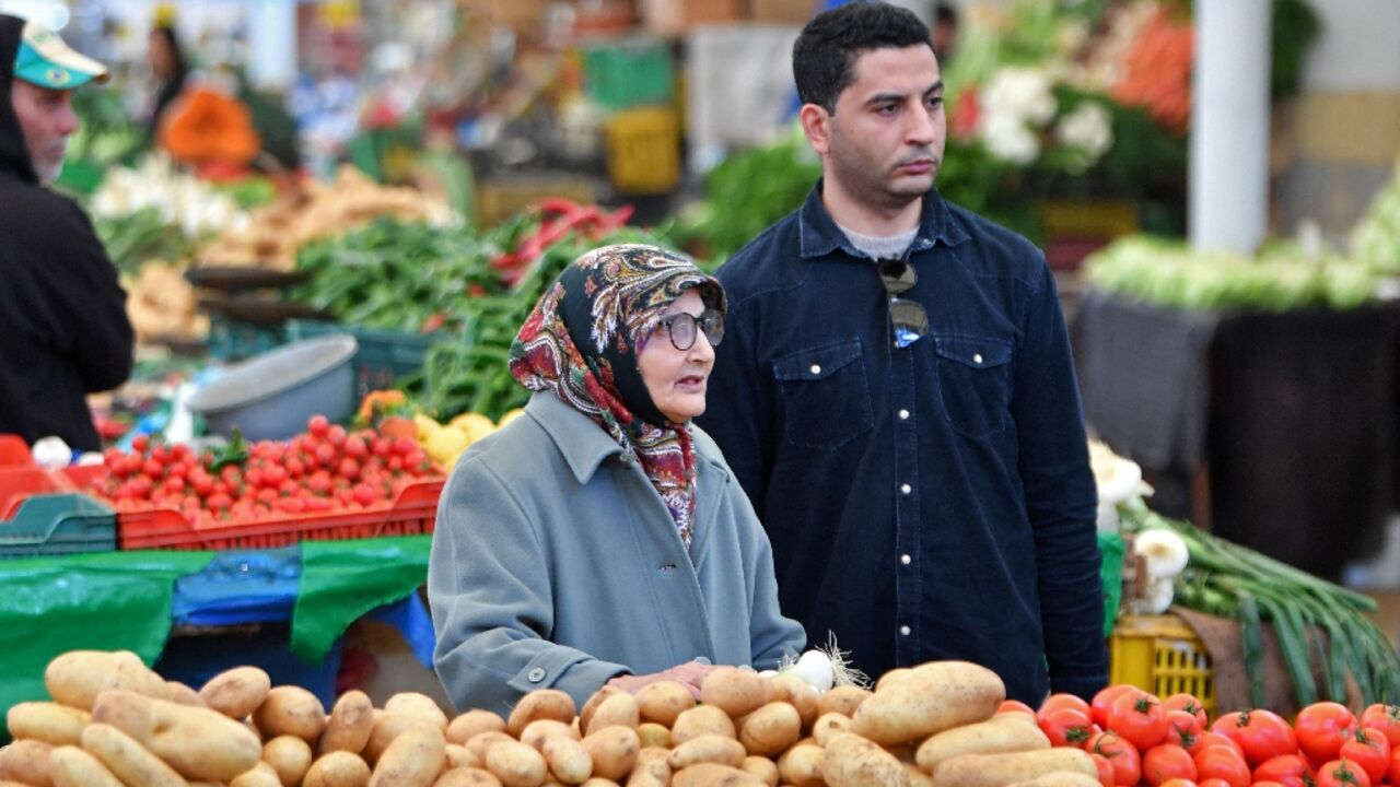 Tunisians shop for vegetables in the capital's central market Tunisians shop for vegetables in the capital's central market