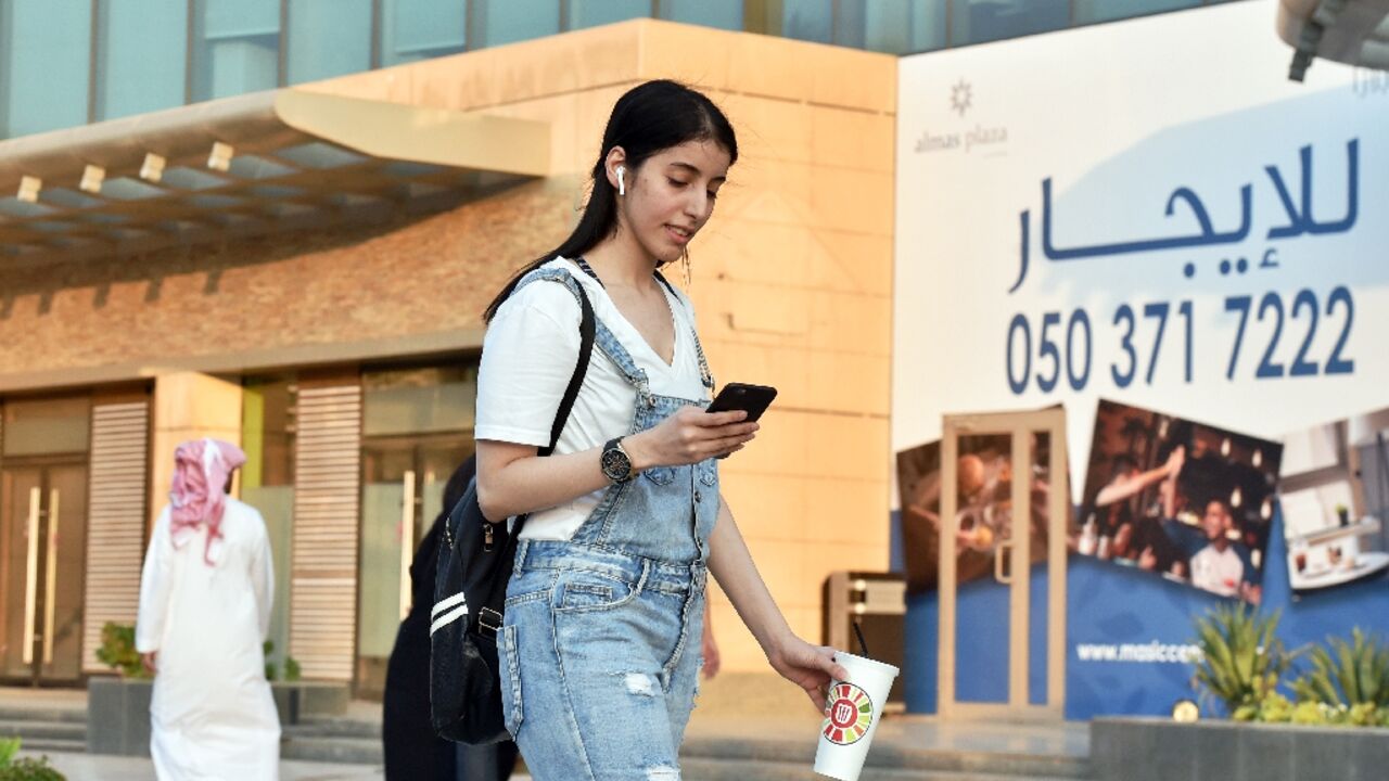 The youngest of the three Otaibi sisters, Manahel, now 29, is photographed walking through the streets of Riyadh in Western dress before her arrest in 2022 for challenging the kingdom's dress code for women