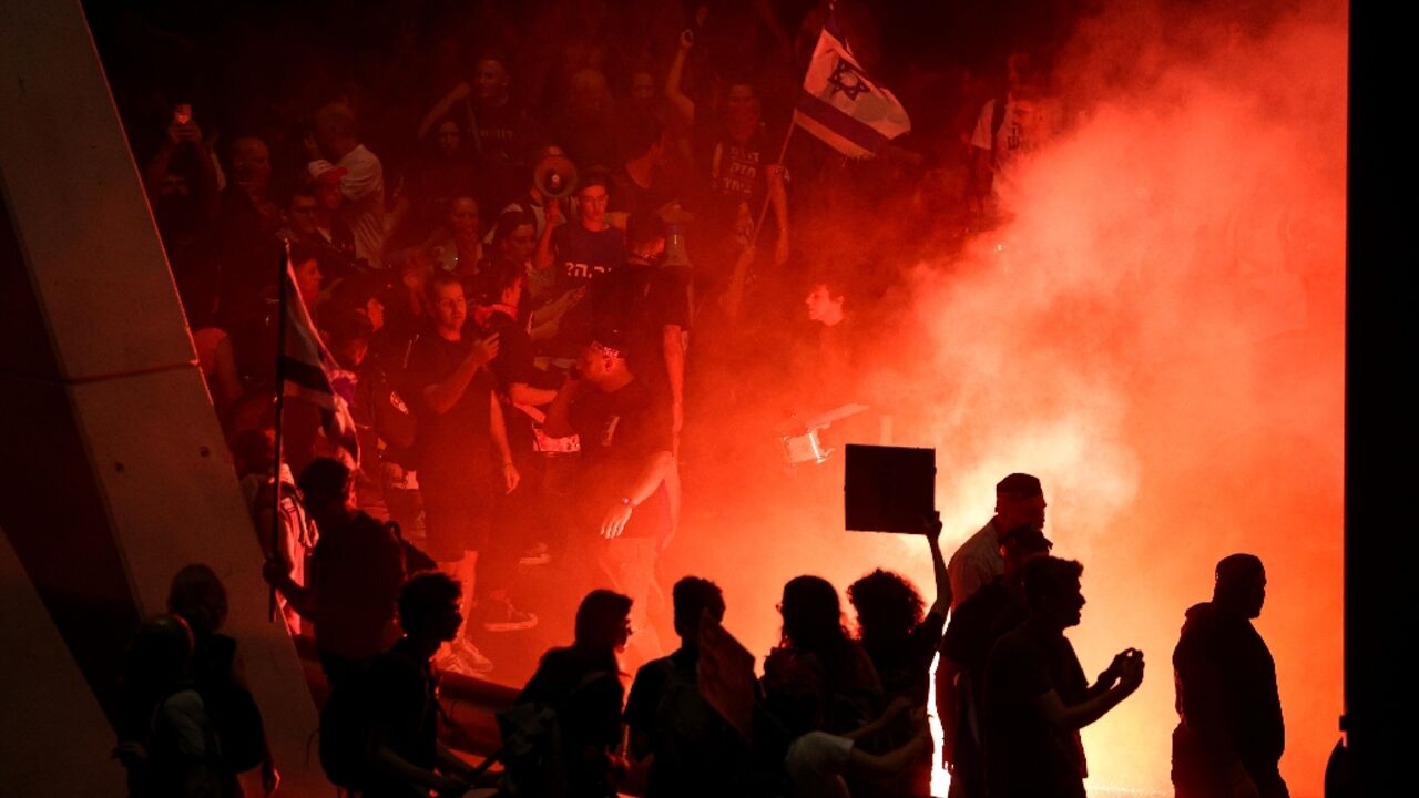 Demonstrators blocked a main city highway, lighting fires and waving Israeli flags