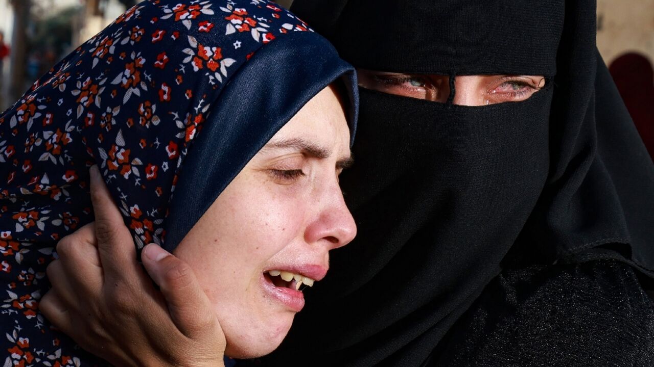 Gaza woman Rania Abu Anza (L), the mother of twins Naeem and Wissam who were killed in an overnight Israeli strike