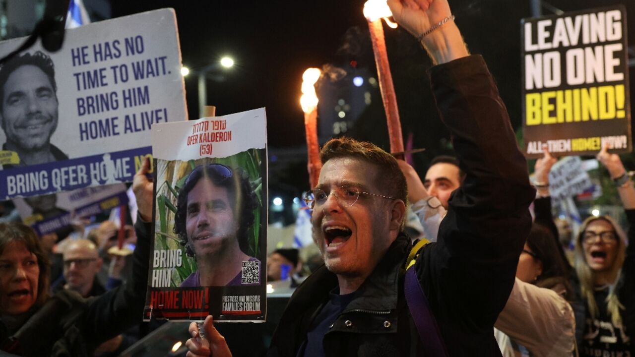 Protesters carry placards during a rally calling for hostage release in Tel Aviv Protesters carry placards during a rally calling for hostage release in Tel Aviv