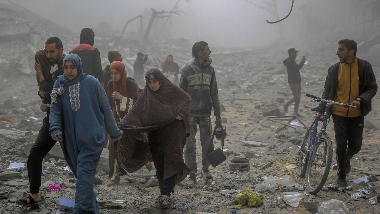 Palestinians flee after Israeli bombardment in central Gaza City on March 18, 2024 amid ongoing battles between Israel and the militant group Hamas Palestinians flee after Israeli bombardment in central Gaza City on March 18, 2024 amid ongoing battles between Israel and the militant group Hamas