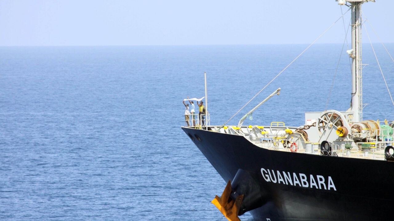 In this handout photo provided by the U.S. Navy, suspected pirates indicate their surrender with a white cloth on the bow of the Japanese-owned commercial oil tanker M/V Guanabara March 6, 2011 in the Arabian Sea. 