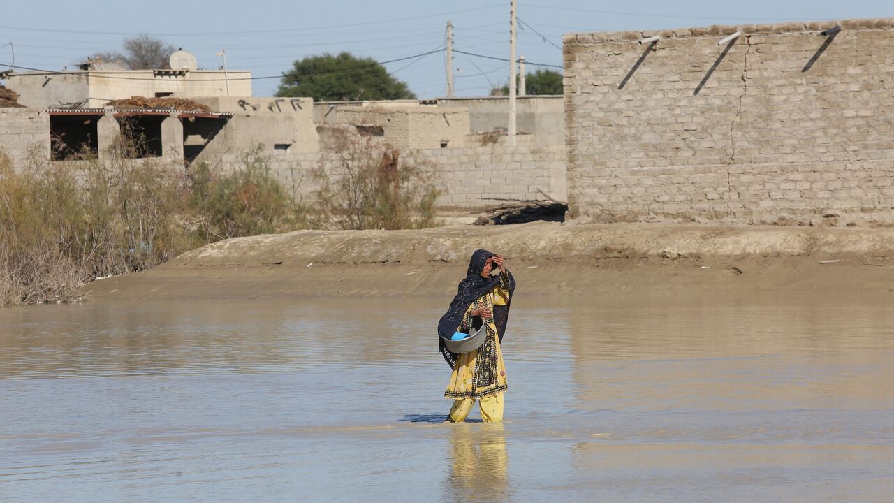 An Iranian woman walks through a flooded road on Jan. 13, 2020.