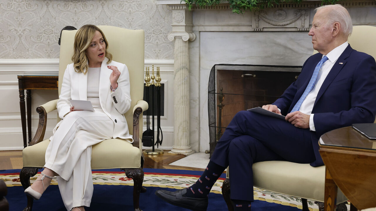US President Joe Biden (R) and Italian Prime Minister Giorgia Meloni react to journalists shouting questions after each leader delivered prepared remarks during a meeting in the Oval Office at the White House on March 1, 2024 in Washington, DC.