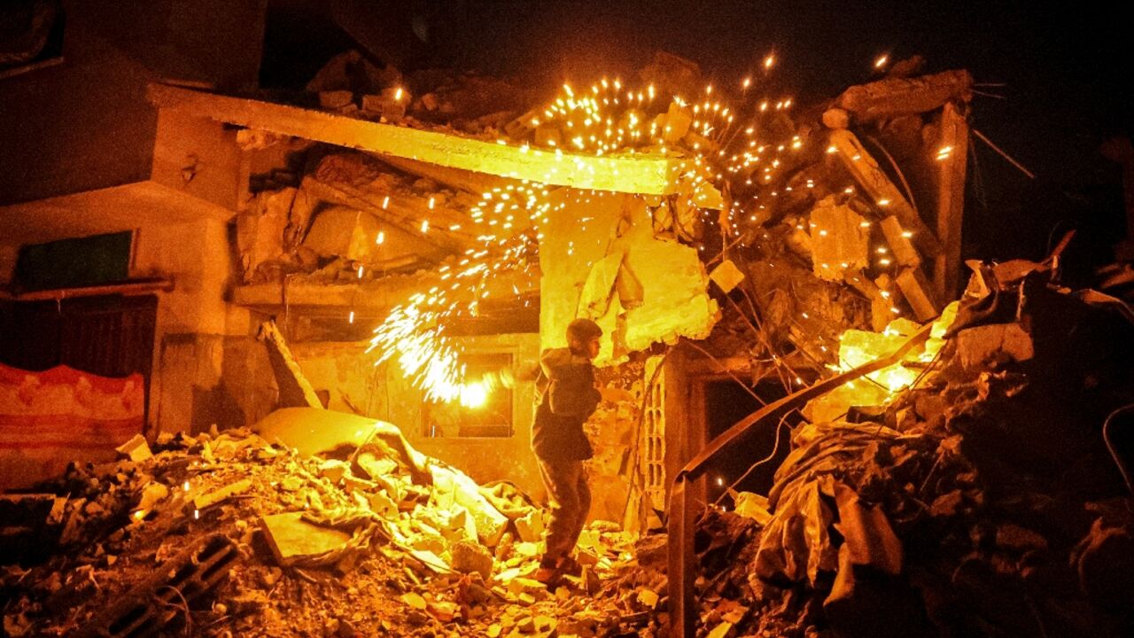 A Palestinian child plays with a sparkler in Rafah,  in southern Gaza, where war has made Ramadan celebrations  muted