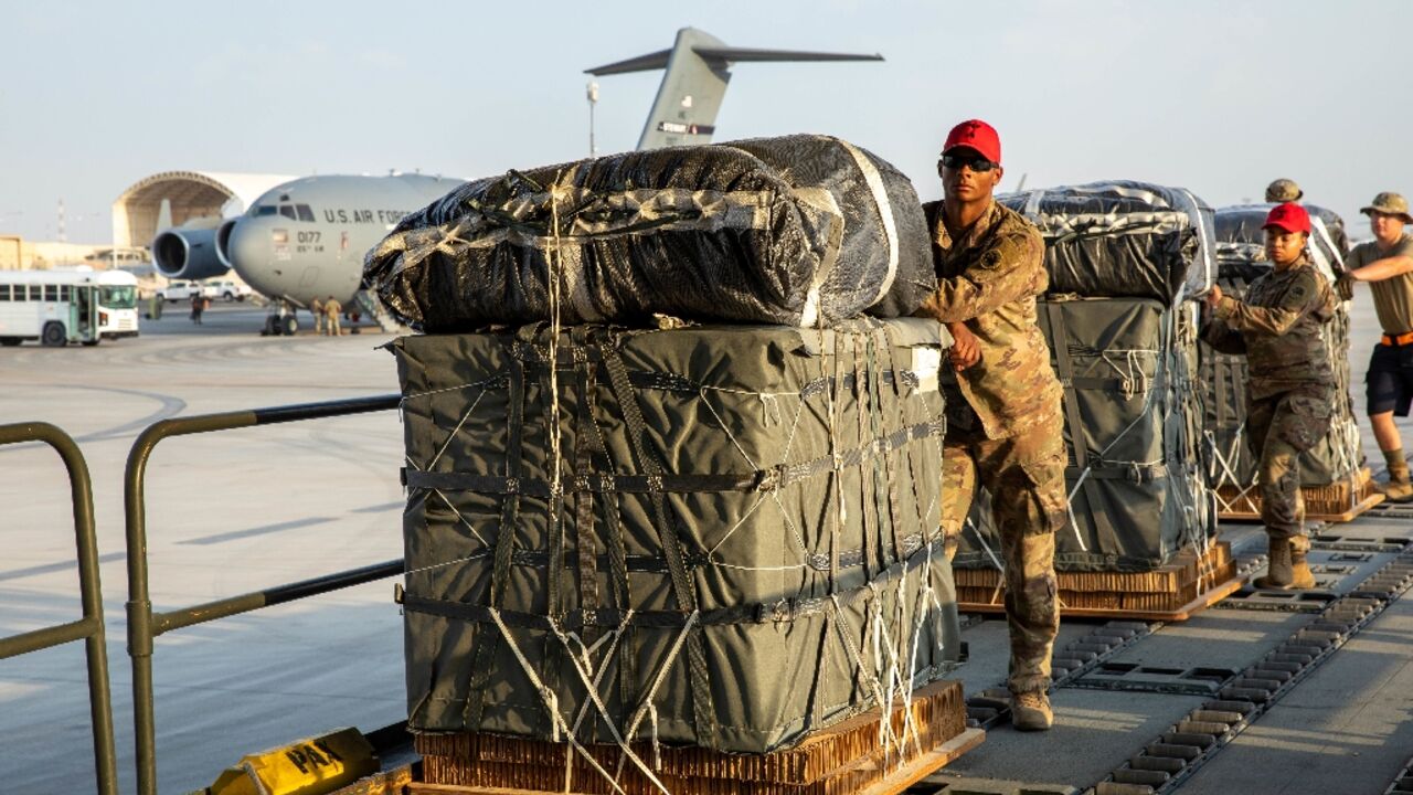 In this image obtained from the US Central Command, military personnel load humanitarian aid into US Air Force C-130 planes on March 5, 2024