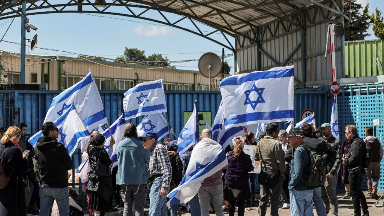 Right-wing Israelis protest outside the West Bank field office of the UN agency for Palestinian refugees (UNRWA) in annexed east Jerusalem calling for its break-up