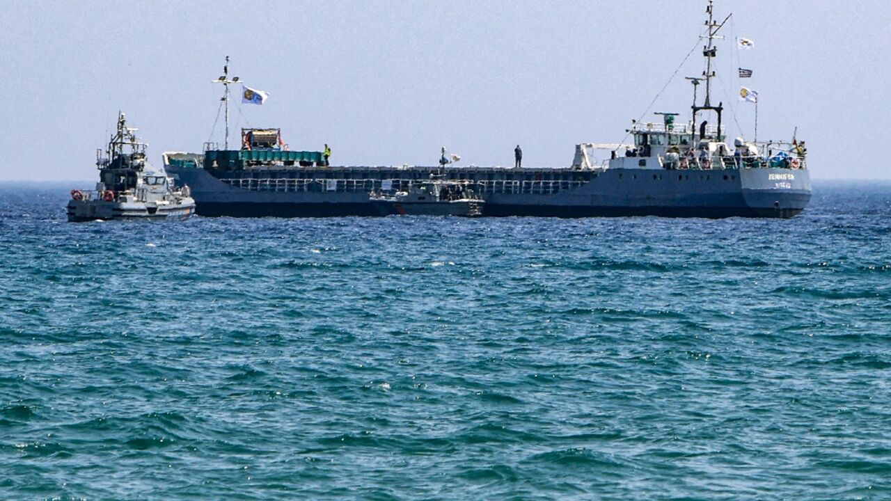 A Cyprus coastguard vessel approaches the aid ship Jennifer off Larnaca ahead of its departure for Gaza