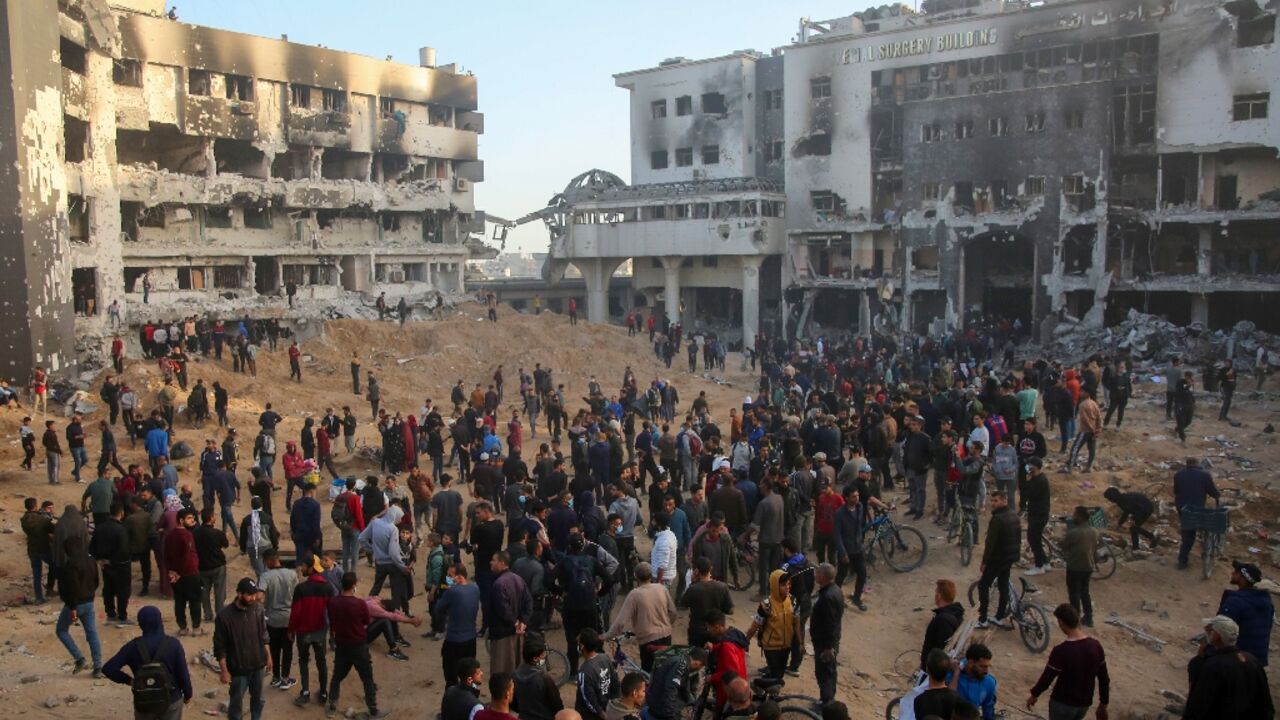 Palestinians inspect the damage at Gaza's Al-Shifa hospital after the Israeli military withdrew from the complex on April 1, 2024