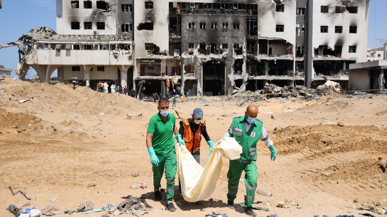 Palestinian forensic and civil defence workers recover human remains from the grounds of Al-Shifa hospital devastated by a two-week Israeli raid Palestinian forensic and civil defence workers recover human remains from the grounds of Al-Shifa hospital devastated by a two-week Israeli raid
