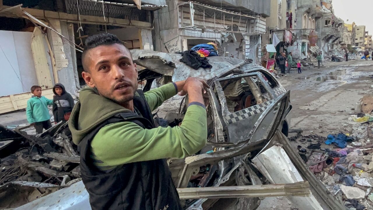 A man gestures in front of the car in which three sons of Hamas leader Ismail Haniyeh were killed 