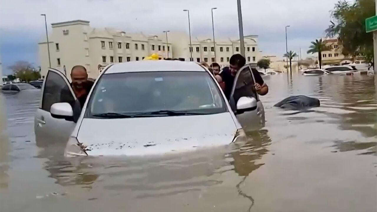 Residents push a waterlogged car along a flooded street in the desert city of Dubai after torrential rains paralysed the Gulf financial and leisure hub Residents push a waterlogged car along a flooded street in the desert city of Dubai after torrential rains paralysed the Gulf financial and leisure hub