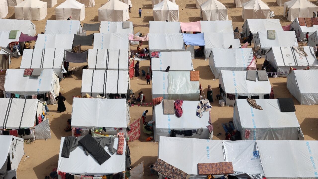 Makeshift camps like this one have been thrown up in every available space around Rafah, which now houses most of the Gaza Strip's population of 2.4 million Makeshift camps like this one have been thrown up in every available space around Rafah, which now houses most of the Gaza Strip's population of 2.4 million