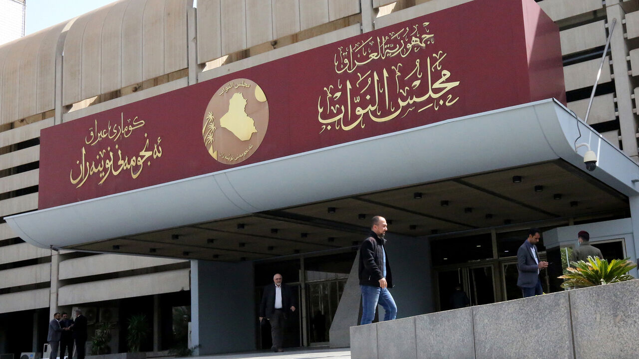 Iraqis stand outside parliament building, or Council of Representatives, in the Green Zone, Baghdad, Iraq, Feb. 27, 2020. 