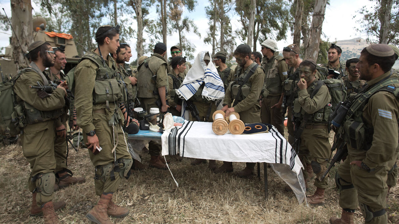 Israeli soldiers of the Netzah Yehuda Battalion hold morning prayers as they take part in their annual unit training in the Israeli annexed Golan Heights, near the Syrian border, May 19, 2014.