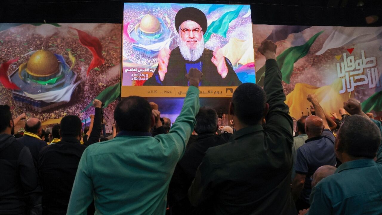 Hezbollah supporters watch their leader Hassan Nasrallah's speech on a big screen at a Quds (Jerusalem) Day gathering in Beirut's southern suburbs Hezbollah supporters watch their leader Hassan Nasrallah's speech on a big screen at a Quds (Jerusalem) Day gathering in Beirut's southern suburbs