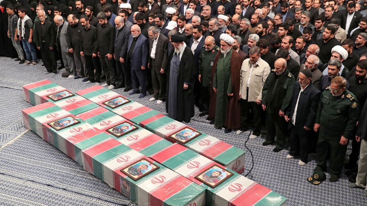 Iran's supreme leader Ayatollah Ali Khamenei prays over the coffins of the seven Revolutionary Guards killed in a strike blamed on Israel in Syria