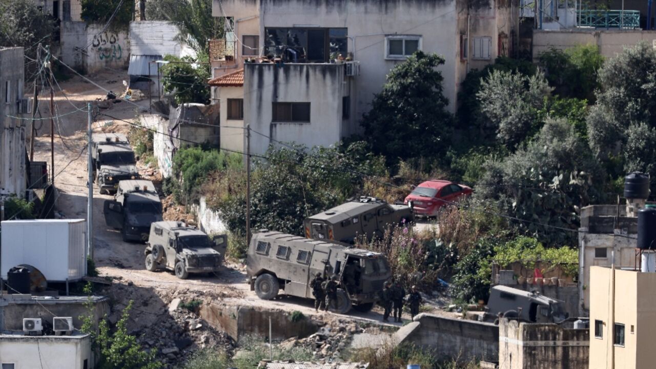 Israeli soldiers line up during a raid in the Nur Shams refugee camp in the occupied West Bank